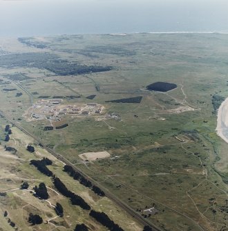 Oblique aerial view of the western rifle ranges with Buddon Camp in the background, taken from the NW.