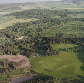 Glamis Castle and Muir House, oblique aerial view, taken from the NNW, centred on Glamis Castle and Gardens. Cropmarks of rig are visible in the foreground.