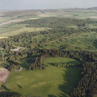 Glamis Castle and Muir House, oblique aerial view, taken from the NW, centred on Glamis Castle and Gardens. Cropmarks of rig are visible in the foreground.