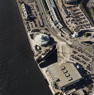 Oblique aerial view centred on the harbour and the Discovery visitor centre, with the leisure centre and railway station adjacent, taken from the ENE.