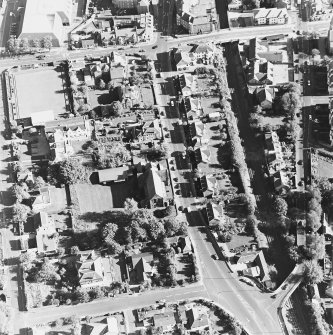 Oblique aerial view centred on the church, taken from the W.