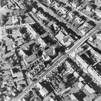 Oblique aerial view centred on the churches and church hall, taken from the SE.