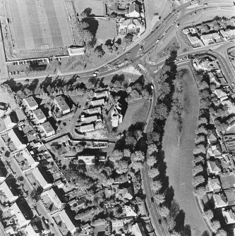 Oblique aerial view centred on the tower-house, taken from the SSE.