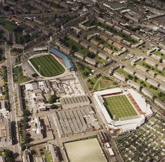 Oblique aerial view centred on the stadium with stadium adjacent, taken from the SSE.