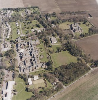 Oblique aerial view centred on the hospital and offices, taken from the WNW.