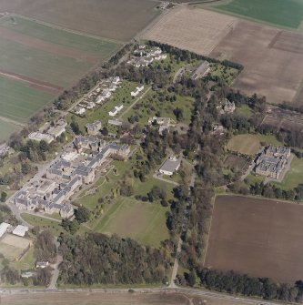 Oblique aerial view centred on the hospital and offices, taken from the WSW.