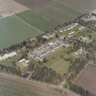 Oblique aerial view centred on the hospital and offices, taken from the SE.