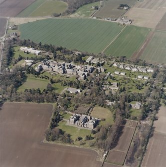 Oblique aerial view centred on the hospital and offices, taken from the SSE.