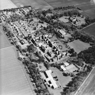 Oblique aerial view centred on the hospital and offices, taken from the WNW.