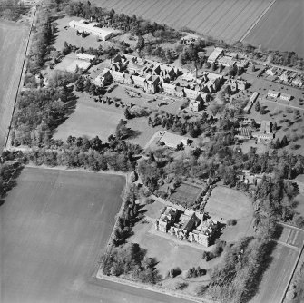 Oblique aerial view centred on the hospital and offices, taken from the SSE.