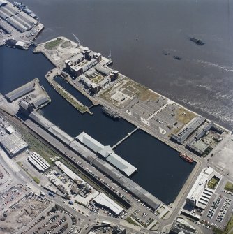 Oblique aerial view centred on the docks and wharf, taken from the WNW.