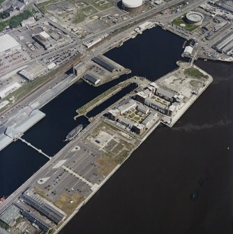 Oblique aerial view centred on the docks and wharf, taken from the SSW.
