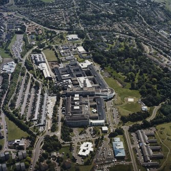 Oblique aerial view centred on the hospital, taken from the WNW.