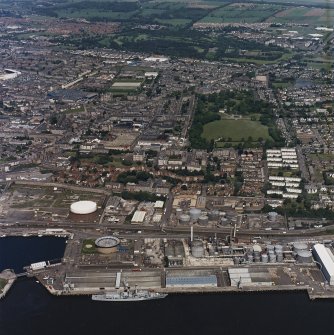 General oblique aerial view of Dundee centred on the park and pavilion with the oil refinery adjacent, taken from the SSE.