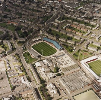 Oblique aerial view centred on the staduim with stadium and jute works adjacent, taken from the SSE.