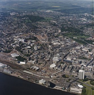 General oblique aerial view of Dundee centred on Westport roundabout with the railway station adjacent, taken from the ESE.