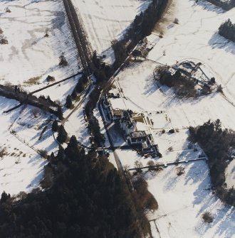 Oblique aerial view centred on the country house and garden, with the dairy and estate offices adjacent, taken from the NNW.