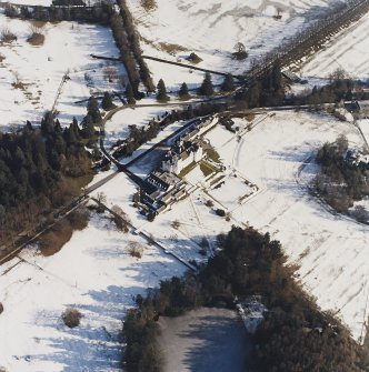 Oblique aerial view centred on the country house and garden, taken from the W.