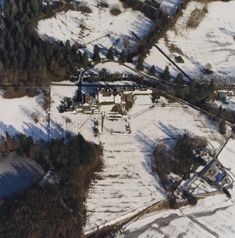 Oblique aerial view centred on the country house and garden, with the dairy adjacent, taken from the SW.