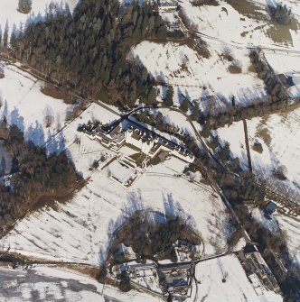 Oblique aerial view centred on the country house and garden, with the dairy and estate offices adjacent, taken from the SSW.