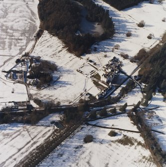 Oblique aerial view centred on the country house and garden, with the dairy and estate offices adjacent, taken from the E.