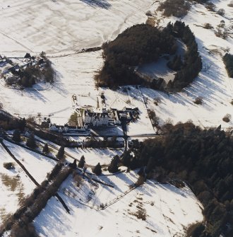 Oblique aerial view centred on the country house and garden, with the dairy adjacent, taken from the NE.