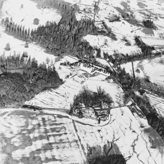 Oblique aerial view centred on the country house and garden, with the dairy and estate offices adjacent, taken from the SSW.