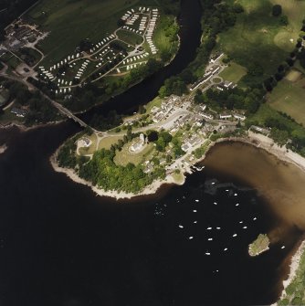 Oblique aerial view of Kenmore centred on the road bridge, church and hotel, and the remains of a crannog with Kenmore Village adjacent, taken from the SSW.