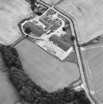 Oblique aerial view centred on the farmhouse and farmsteading, taken from the WNW