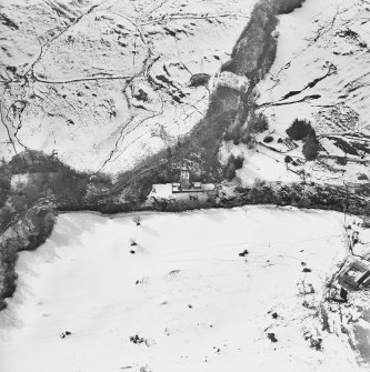 Oblique aerial view centred on the castle and tower-house, taken from the ENE.