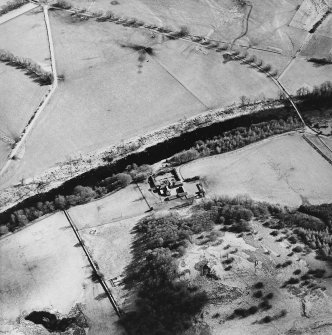 Oblique aerial view centred on the farmstead, taken from the WNW.