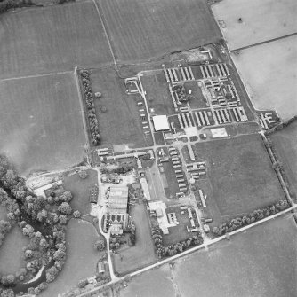 Oblique aerial view centred on the military camp with the bunker, observation post and remains of the church and graveyard adjacent, taken from the SSE.