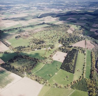 General oblique aerial view looking across the country house and policies towards Perth, taken from the SW.