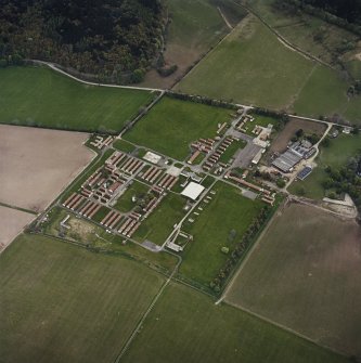 Oblique aerial view centred on the military camp with the bunker, observation post and remains of the church and graveyard adjacent, taken from the WNW.