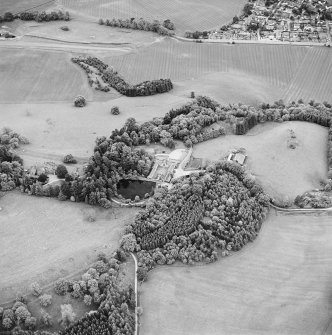 Oblique aerial view of Lude House centred on the country house and farmsteading, taken from the NNE.