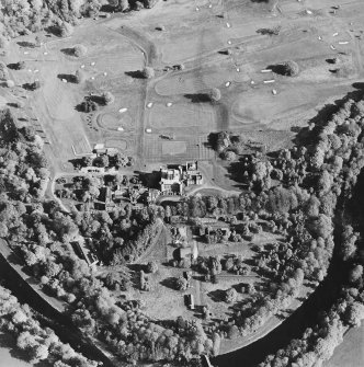Oblique aerial view centred on the country house with golf club house and remains of military camp adjacent, taken from the NW.