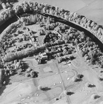 Oblique aerial view centred on the country house with golf club house and remains of military camp adjacent, taken from the SSE.
