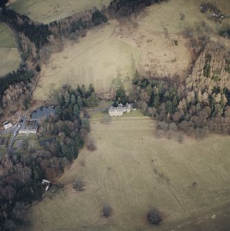 Oblique aerial view centred on the country house with farmsteading adjacent, taken from the SW.