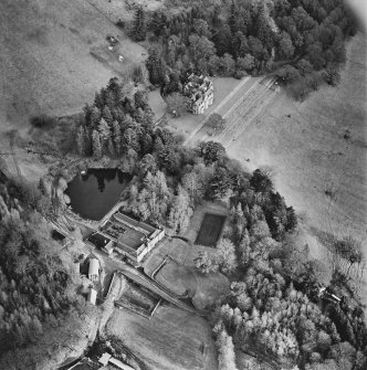 Oblique aerial view centred on the country house with farmsteading adjacent, taken from the W.
