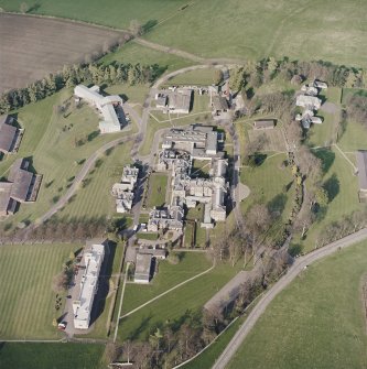Oblique aerial view centred on the hospital and chapel, taken from the WSW.