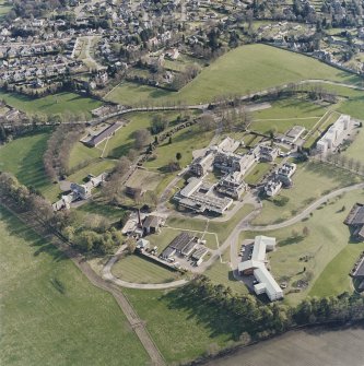 Oblique aerial view centred on the hospital and chapel with the remains of the rig adjacent, taken from the NNE.