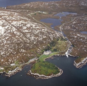 Oblique aerial view centred on the country house with the pier adjacent, taken from the WSW.