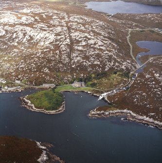 Oblique aerial view centred on the country house with the pier adjacent, taken from the SW.