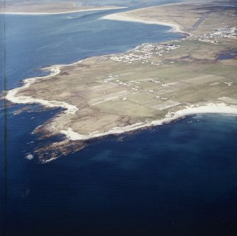 General oblique aerial view looking across the bay of Culla towards the crofting township of Aird with the township of Balvanich and Benbecula aerodrome beyond, taken from the WSW.