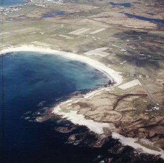 General oblique aerial view looking across the bay of Culla towards the township of Balvanich, taken from the SW.