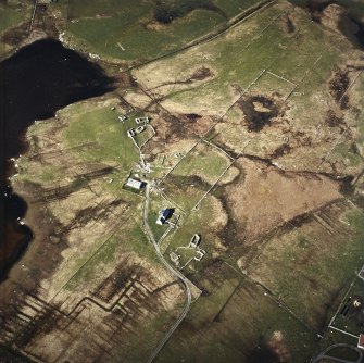 Oblique aerial view centred on the remains of the farmsteads and the houses, taken from the SSE.