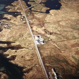 Oblique aerial view centred on the hotel, with the site of the post office adjacent taken from the S.