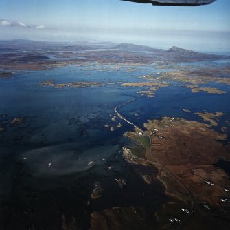 General oblique aerial view centred on the causeway, looking across Grimsey towards Eavel in the distance, taken from the SW.