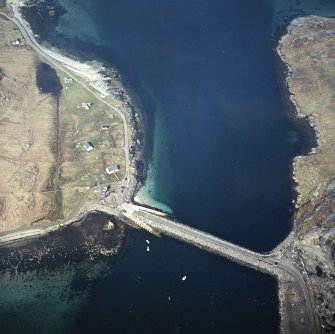 Oblique aerial view centred on the causeway and slipways with the crofting township adjacent, taken from the ESE.