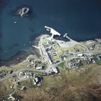 Oblique aerial view centred on the town with the tower-house, church and pier adjacent, taken from the NE.